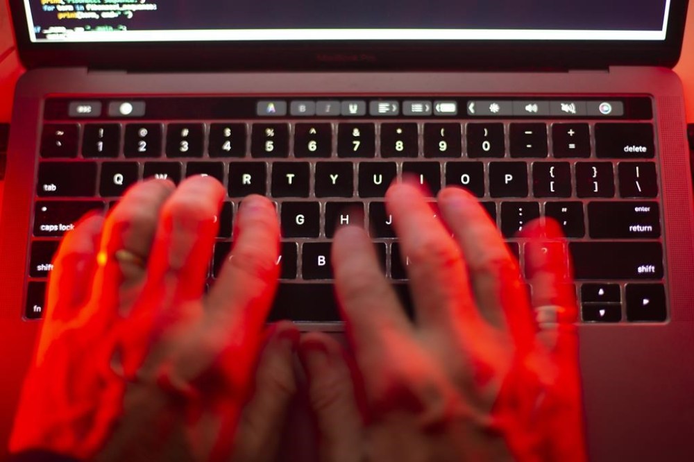 A man uses a computer keyboard in Toronto in this Sunday, Oct. 9, 2023 photo illustration. All Calgary Public Library locations have been closed due to a cybersecurity breach. THE CANADIAN PRESS/Graeme Roy