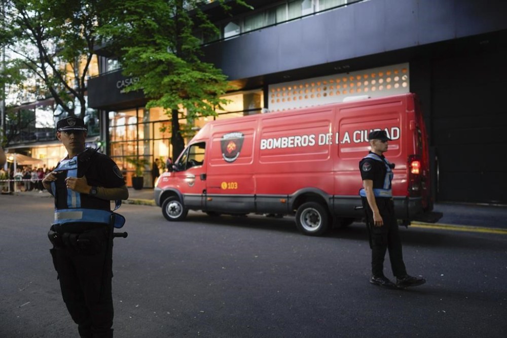 Police stand guard outside a hotel where Liam Payne, a former member of the band One Direction, was found dead after falling from a balcony in Buenos Aires, Argentina, Wednesday, Oct. 16, 2024. (AP Photo/Natacha Pisarenko)