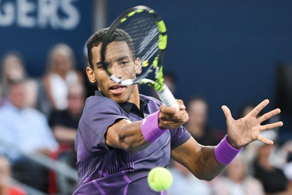 Felix Auger-Aliassime of Canada plays a shot to Flavio Cobolli of Italy during their first round match at the National Bank Open tennis tournament in Montreal, Wednesday, August 7, 2024. Felix Auger-Aliassime's losing streak on the ATP Tour came to an end Wednesday with a 6-7 (4), 6-4, 6-2 win over Marton Fucsovics in second-round action at the European Open. THE CANADIAN PRESS/Graham Hughes