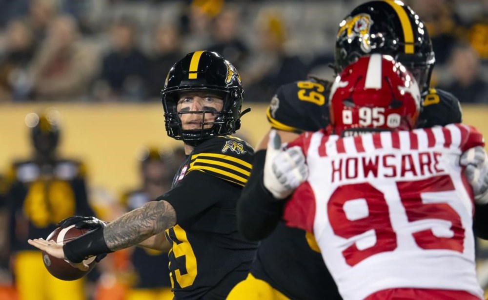 Hamilton Tiger Cats quarterback Bo Levi Mitchell (19) looks to make the pass during CFL football action against the Calgary Stampeders in Hamilton, Ont. on Friday, October 18, 2024. THE CANADIAN PRESS/Peter Power