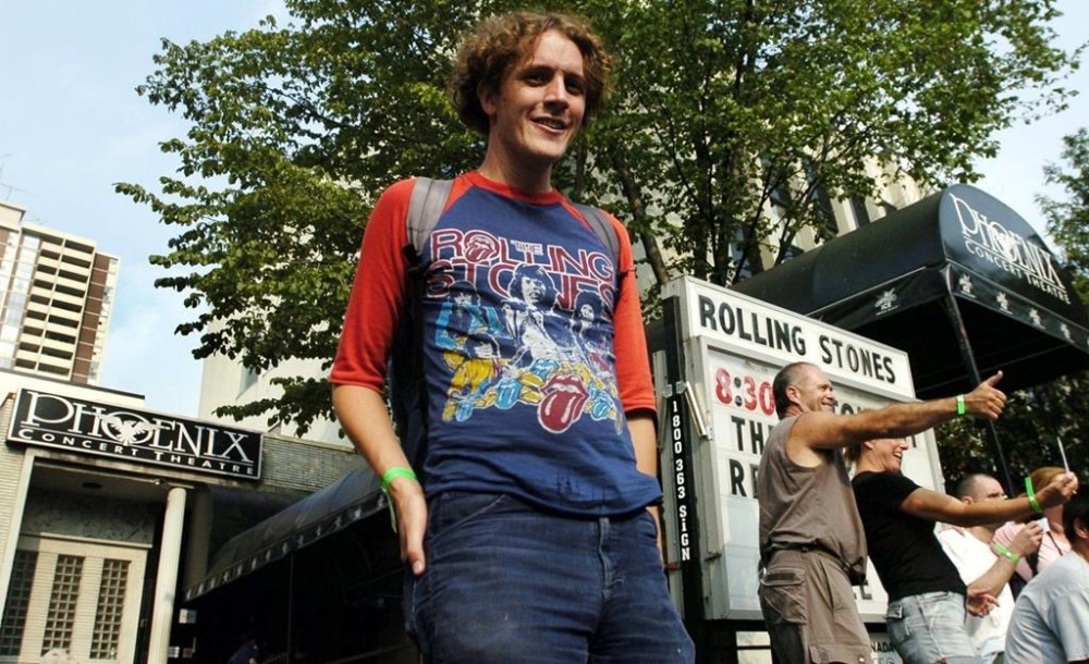 A man leaves the Phoenix Concert Theatre with his ticket for the Rolling Stones show in Toronto on Aug. 10, 2005. THE CANADIAN PRESS/Aaron Harris