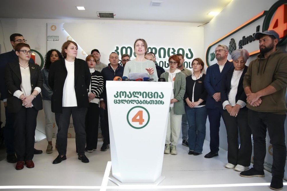 Nana Malashkhia, who leads the Coalition for Change parliament list, center, speaks to the media at coalition's headquarters after the parliamentary election in Tbilisi, Georgia, Sunday, Oct. 27, 2024. (AP Photo/Zurab Tsertsvadze)