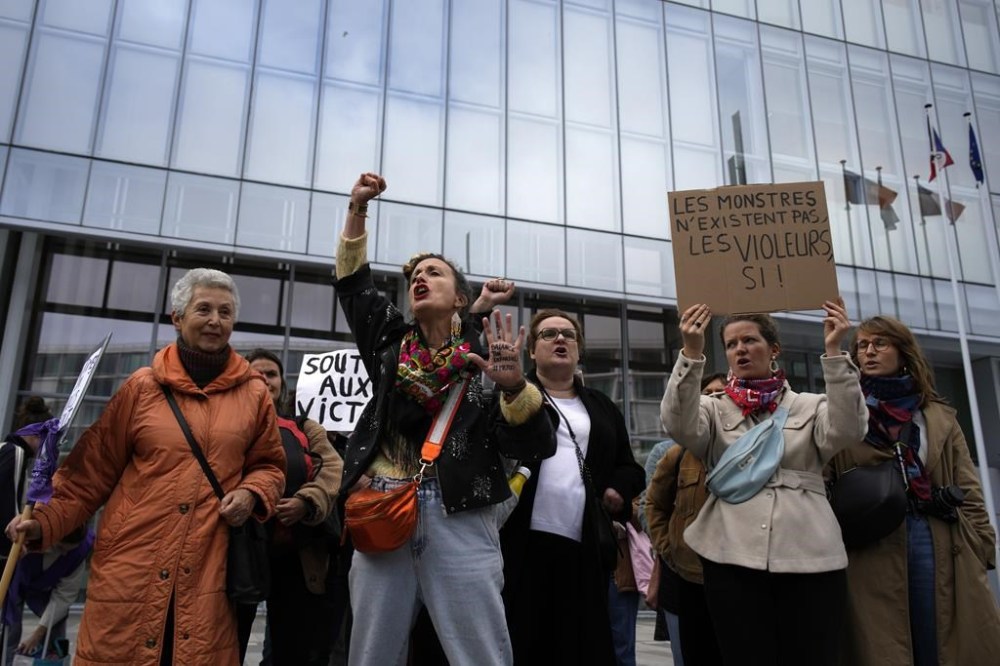 Women's rights activists demonstrate outside the Paris palace of justice as French actor Gérard Depardieu, who is facing trial for the alleged sexual assaults of two women on a film set in 2021, won't appear before a criminal court, Monday, Oct. 28, 2024 in Paris. (AP Photo/Louise Delmotte)