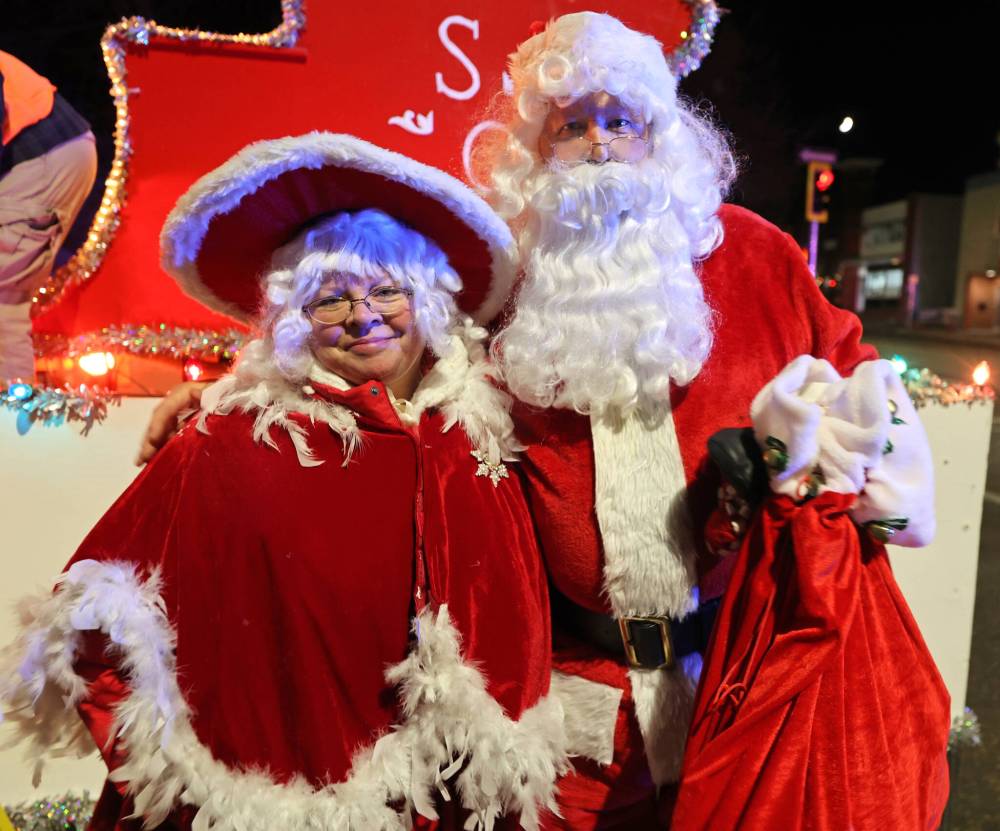 Mr. and Mrs. Claus pose for a photo in 2023 before climbing up onto the Santa sleigh that is traditionally placed at the end of the Brandon Santa Parade. (File)