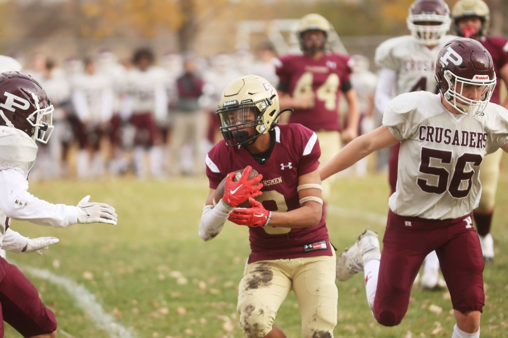 Seth McCauley (8) of Crocus runs the ball against St. Paul's.
