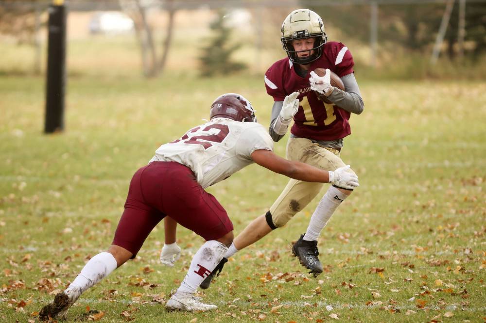 Quarterback Simon Leckie (11) of the Crocus Plainsmen runs the ball during high school football action against the St. Paul's Crusaders at CPRSS on a warm Thursday. (Photos by Tim Smith/The Brandon Sun)