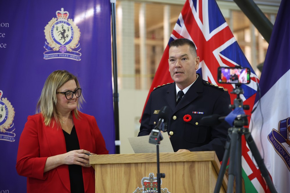 Judge Shauna Hewitt-Michta looks on as new Brandon Police Service Chief Tyler Bates recites his oath of office and oath of allegiance during his swearing in ceremony at the Brandon Armoury on Wednesday.