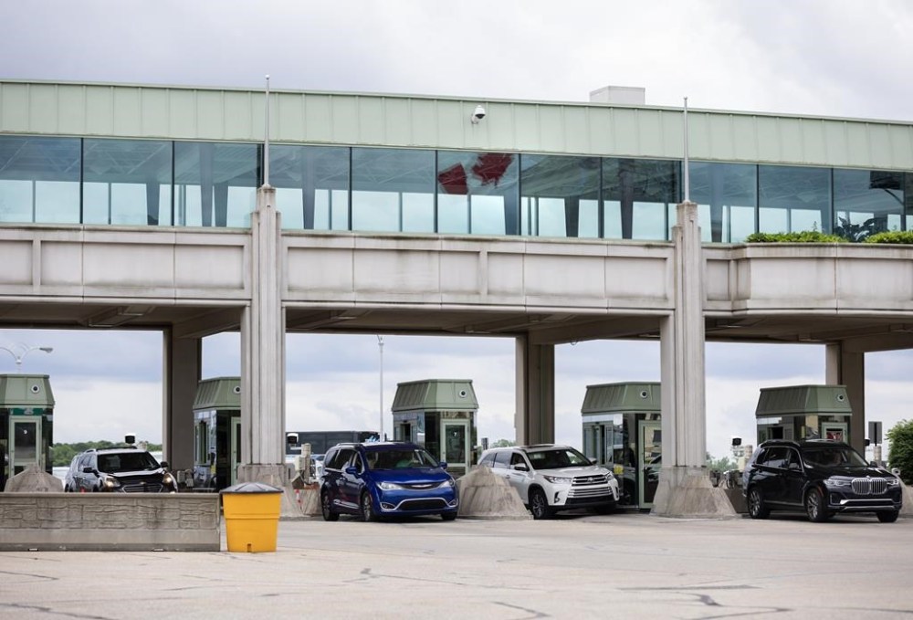 Canada Border Services Agency officers speak with travellers crossing at the Niagara Falls International Rainbow Bridge in Niagara Falls, Ont., Friday, June 7, 2024. THE CANADIAN PRESS/Aaron Lynett