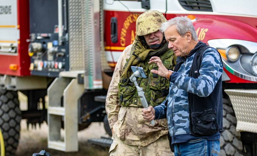 A still image from shooting the movie, “Fallen Heroes Their Journey Home,” showing tonight and Wednesday at Landmark Cinemas at 7 p.m. The film tells the story of a Canadian soldier who fought for a ramp ceremony in Afghanistan, to honour four soldiers who were killed by an American bomb in 2002. In this image, Robert Curtin (right), the film’s director, instructs Warrant Officer Glenn Miller, (retired) while on location at CFB Suffield in Alberta. (Photo courtesy of Zak Souter-Lucase)