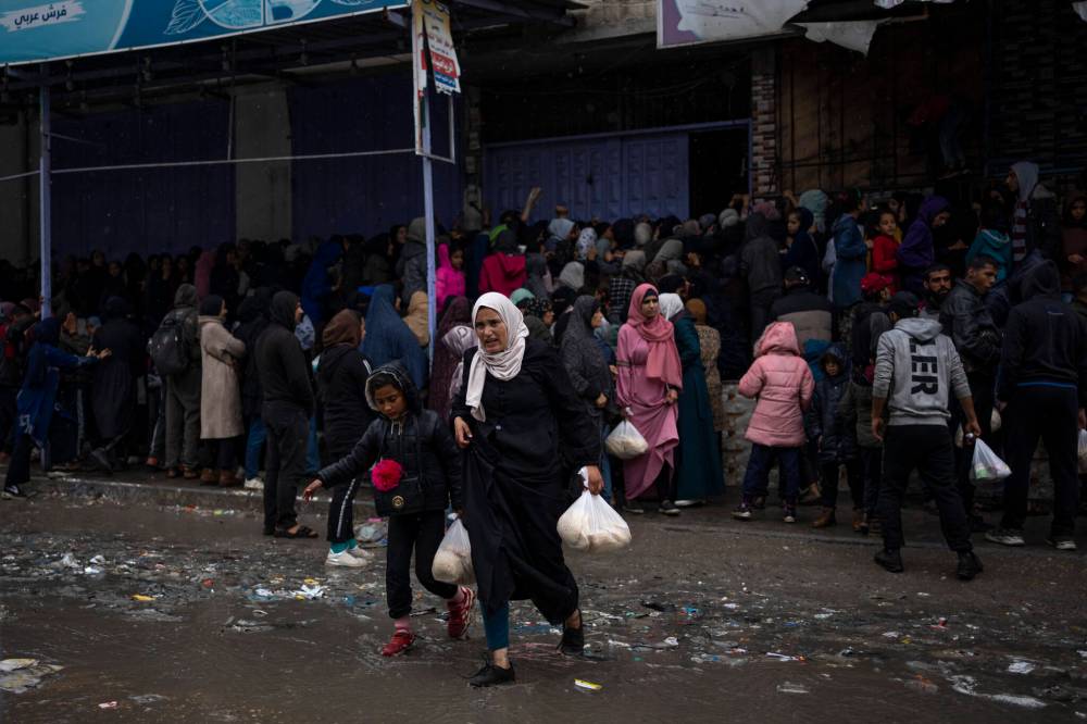 Palestinian crowds struggle to buy bread from a bakery in Rafah, in the Gaza Strip. (The Associated Press)