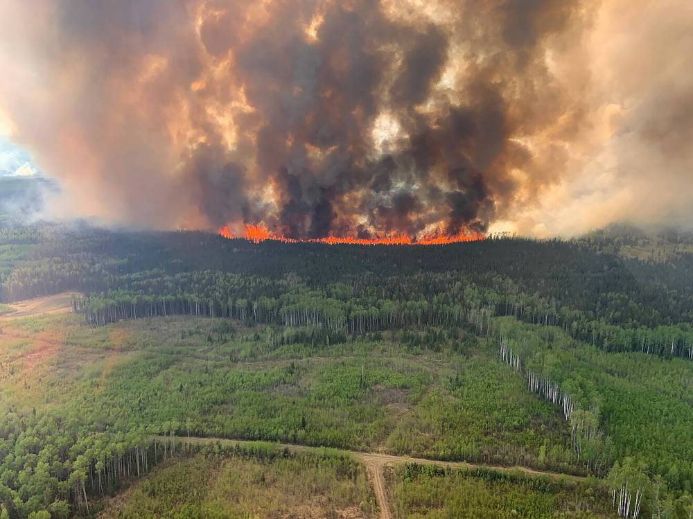 Shown here is a 2023 Alberta wildfire. Such fires are one reason the Earth can’t absorb as much CO2 as it used to. The threat of climate change can seem overwhelming, but there are ways that local youth can do their part. (File)