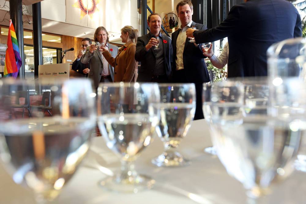 Dignitaries including Brandon Mayor Jeff Fawcett (second from left) make a toast with glasses of water during an announcement at Brandon City Hall on Tuesday. The City of Brandon and Fusion Credit Union are partnering with the province and the Canada Infrastructure Bank for water and wastewater infrastructure projects. (Tim Smith/The Brandon Sun)