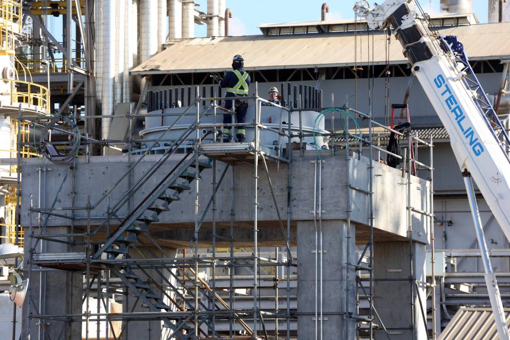 Workers were busy Wednesday preparing to install the new convertor.
