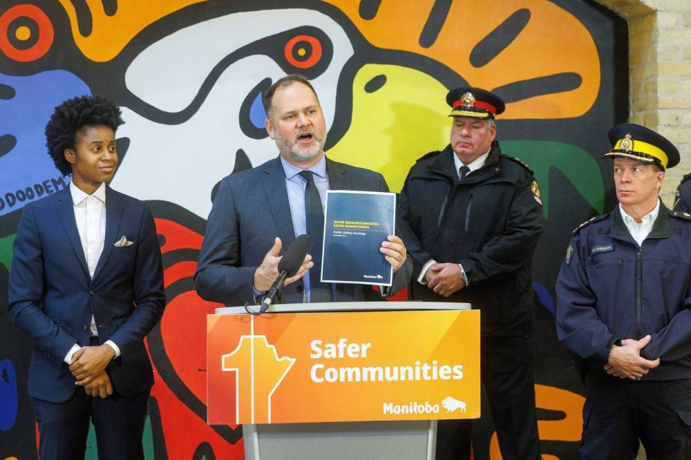 Justice Minister Matt Wiebe unveils the new Safer Neighbourhoods, Safer Downtowns Public Safety Strategy, which they claim will be a road map for a safer Manitoba, during a press conference in Winnipeg on Thursday afternoon. (Mike Deal/Winnipeg Free Press)