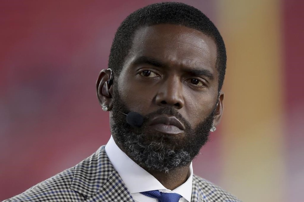 FILE Broadcaster Randy Moss sits on the sideline before an NFL football game between the San Francisco 49ers and the Los Angeles Rams, Monday, Nov. 15, 2021, in Santa Clara, Calif. (AP Photo/Scot Tucker, File)