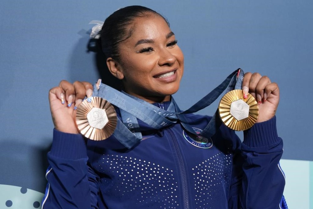 FILE - Jordan Chiles, of the United States, holds up her medals after the women's artistic gymnastics individual apparatus finals Bercy Arena at the 2024 Summer Olympics, on Aug. 5, 2024, in Paris, France. (AP Photo/Charlie Riedel, File)