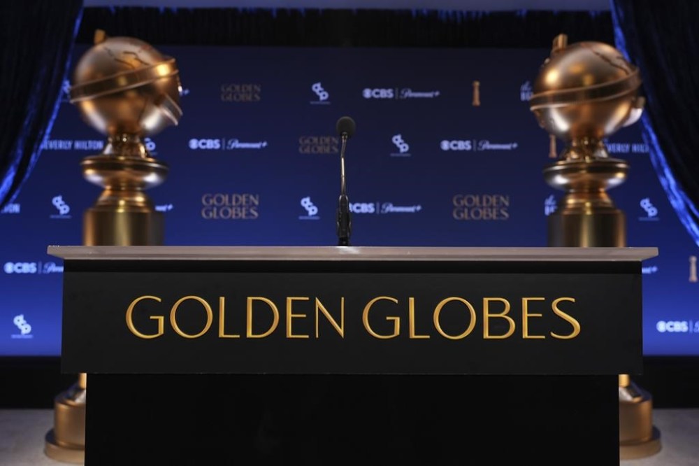 A podium and replicas of Golden Globe statues appear prior to the nominations announcement for the 82nd Golden Globes on Monday, Dec. 9, 2024, at the Beverly Hilton Hotel in Beverly Hills, Calif. The 82nd Golden Globes will be held on Sunday, Jan. 5, 2025. (AP Photo/Chris Pizzello)