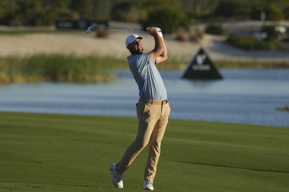 Scottie Scheffler, of the United States, watches his shot from the 18th fairway during the final round of the Hero World Challenge PGA Tour at the Albany Golf Club in New Providence, Bahamas, Sunday, Dec. 8, 2024. (AP Photo/Fernando Llano)