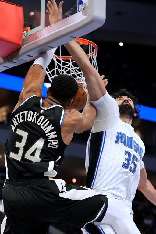 Milwaukee Bucks' Giannis Antetokounmpo dunks =ast Orlando Magic's Goga Bitadze during the second half of an Emirates NBA cup tournament quarterfinals basketball game Tuesday, Dec. 10, 2024, in Milwaukee. (AP Photo/Morry Gash)