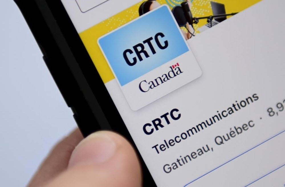 A person navigates to the social media pages of the Canadian Radio-television and Telecommunications Commission (CRTC) on a cellphone in Ottawa on Monday, May 17, 2021. THE CANADIAN PRESS/Sean Kilpatrick