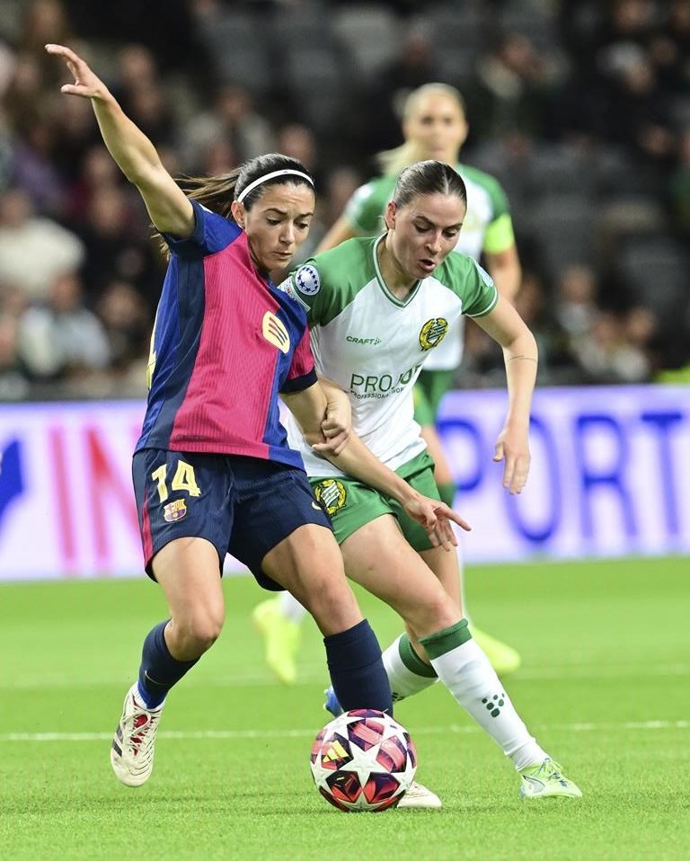 Barcelona's Aitana Bonmatí, left, and Hammarby's Smilla Vallotto in action during the Champions League group D women's soccer match between Hammarby IF and FC Barcelona at Stockholm Arena in Stockholm, Sweden, Thursday Dec. 12, 2024. (Jonas Ekströmer/TT via AP)