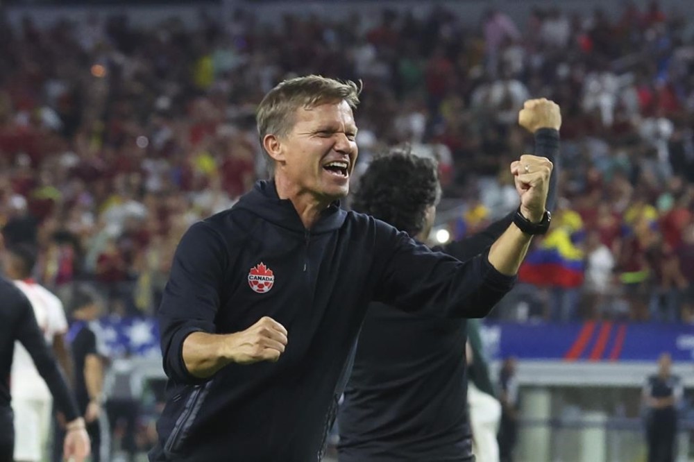 Canada head coach Jesse Marsch celebrates the team's win in a Copa America quarterfinal soccer match between Venezuela and Canada in Arlington, Texas, Friday, July 5, 2024. THE CANADIAN PRESS/AP/Richard Rodriguez