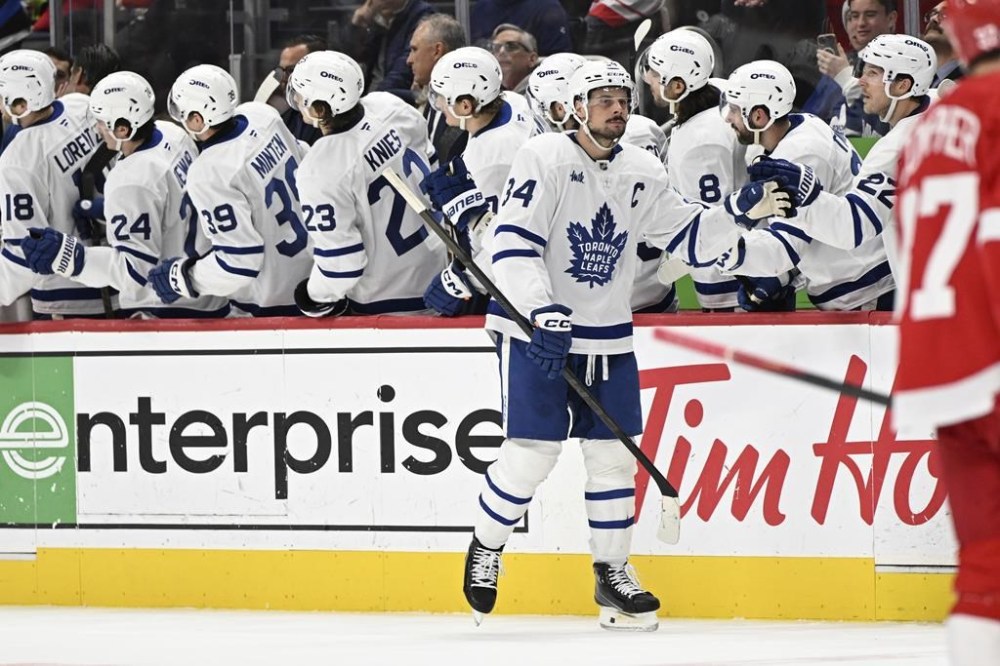 Toronto Maple Leafs center Auston Matthews (34) celebrates after scoring a goal against the Detroit Red Wings during the second period of an NHL hockey game, Saturday, Dec. 14, 2024 in Detroit. (AP Photo/Lon Horwedel)