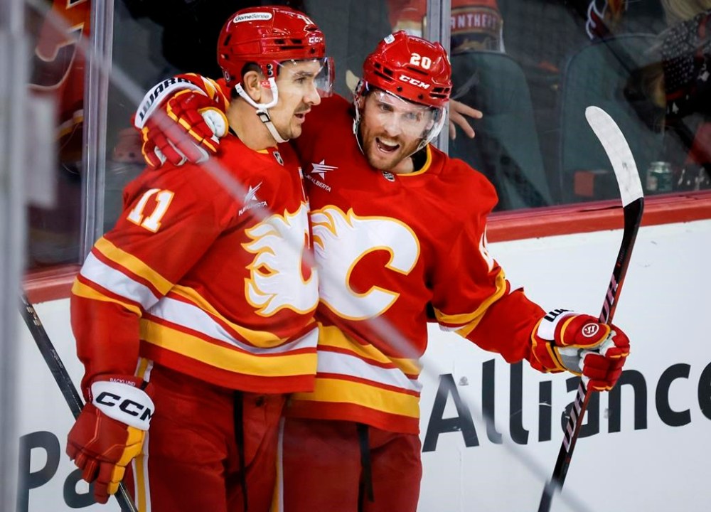 Calgary Flames' Mikael Backlund, left, celebrates his goal with teammate Blake Coleman during third period NHL hockey action against the Florida Panthers in Calgary, Alta., Saturday, Dec. 14, 2024. THE CANADIAN PRESS/Jeff McIntosh