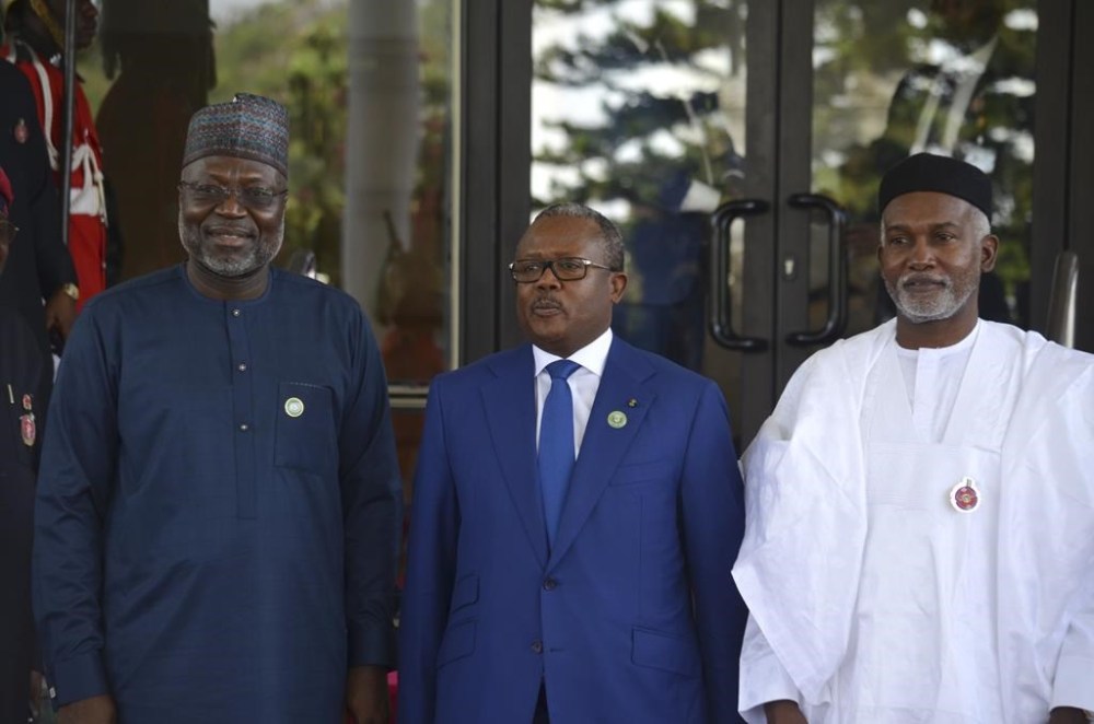 Omar Touray, president of the ECOWAS Commission, left, Guninea Bissau President Umaro Sissoco Embalo, center and Nigeria Minister of Foreign Affairs, Yusuf Tuggar pose for a photo, prior to the start of the ECOWAS meeting in Abuja, Nigeria, Sunday, Dec 15, 2024. (AP Photo/Olamikan Gbemiga)