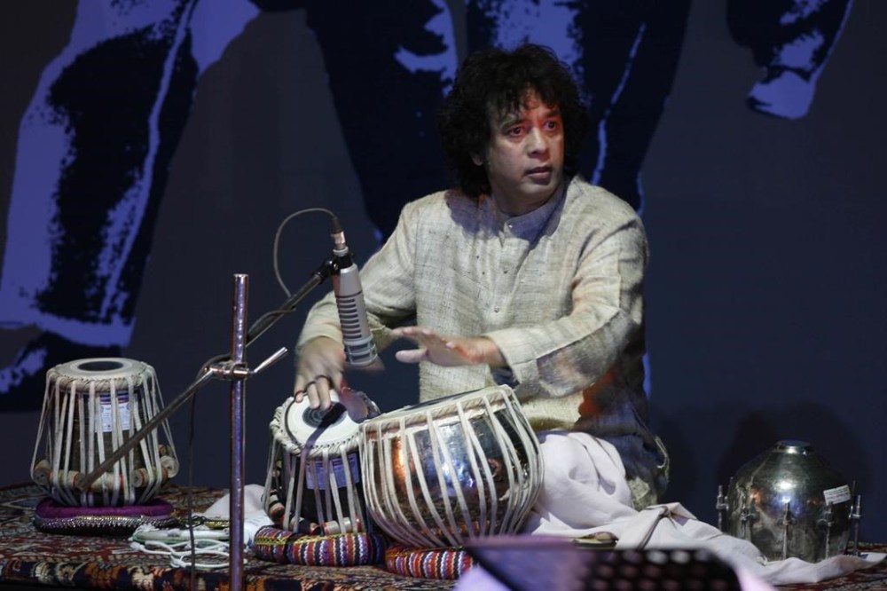 FILE - Indian drum maestro Zakir Hussain performs at the