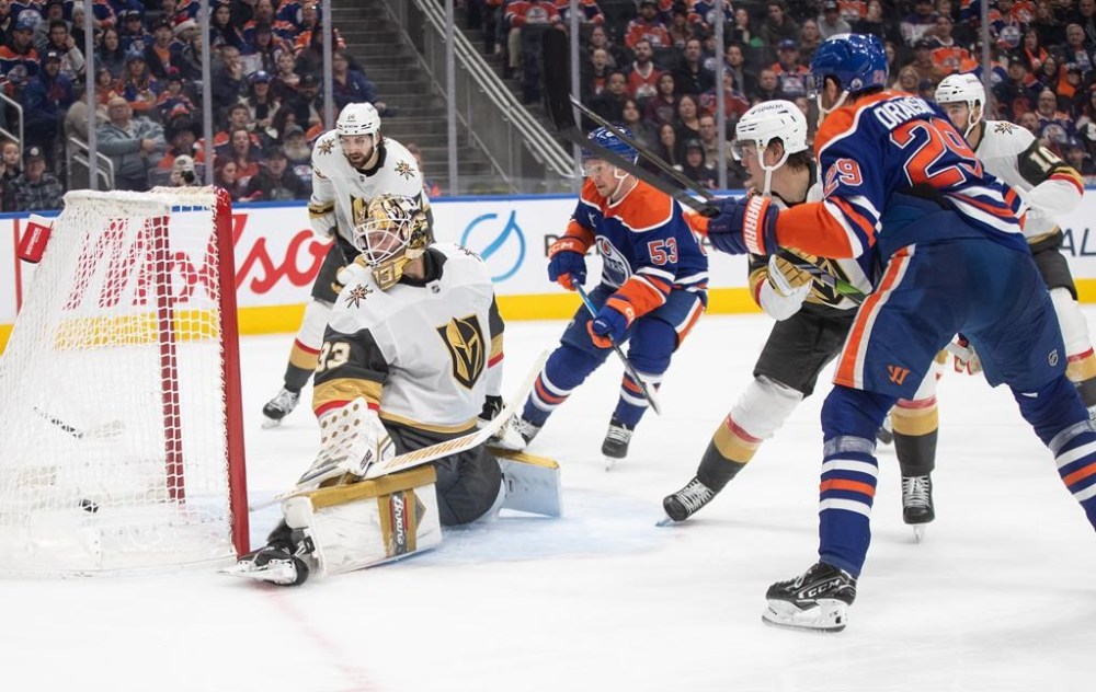 Vegas Golden Knights goalie Adin Hill (33) is scored on by Edmonton Oilers' Leon Draisaitl (29) during second period NHL action in Edmonton, Saturday, Dec. 14, 2024. THE CANADIAN PRESS/Jason Franson