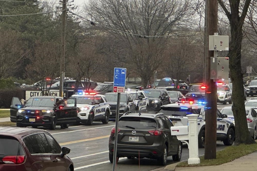 Emergency vehicles are parked outside the Abundant Life Christian School in Madison, Wis., where multiple injuries were reported following a shooting, Monday, Dec. 16, 2024. (AP Photo/Scott Bauer)