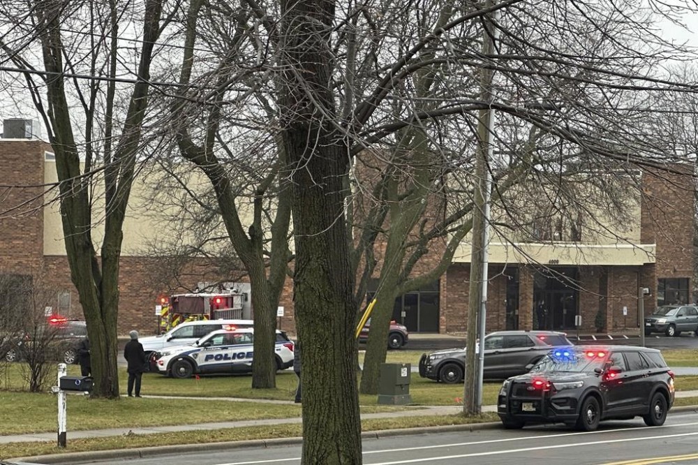 Emergency vehicles are parked outside the Abundant Life Christian School in Madison, Wis., where multiple injuries were reported following a shooting, Monday, Dec. 16, 2024. (AP Photo/Scott Bauer)