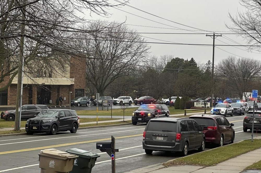 Emergency vehicles are parked outside the Abundant Life Christian School in Madison, Wis., where multiple injuries were reported following a shooting, Monday, Dec. 16, 2024. (AP Photo/Scott Bauer)