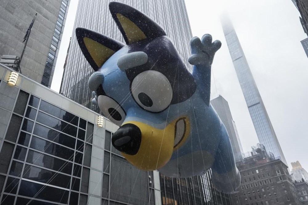 Handlers guide the Bluey balloon down Sixth Avenue during the Macy's Thanksgiving Day Parade, Thursday, Nov. 28, 2024, in New York. (AP Photo/Julia Demaree Nikhinson)