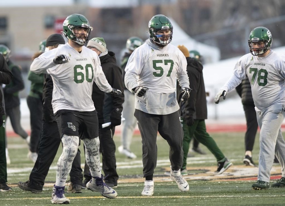 Saskatchewan University Huskies offensive line players Noah Zerr, from left, Brice Zerr and Connor Delahey warm up during practice, in Quebec City, Friday, Dec. 3, 2021. The Roughriders signed Zerr to a one-year contract extension Tuesday.THE CANADIAN PRESS/Jacques Boissinot