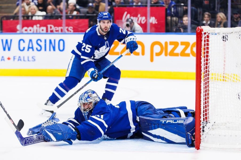 Toronto Maple Leafs goaltender Anthony Stolarz (41) is scored on by Washington Capitals centre Connor McMichael, not shown, as Maple Leafs' Conor Timmins (25) looks on during third-period NHL hockey action in Toronto on Friday, Dec. 6, 2024. Leafs goaltender Stolarz will undergo knee surgery and miss four to six weeks, general manager Brad Treliving said Tuesday. THE CANADIAN PRESS/Cole Burston