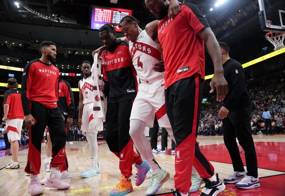 Toronto Raptors forward Scottie Barnes (4) is helped off the court after suffering an injury during second half NBA basketball action against the New York Knicks, in Toronto, Monday, Dec. 9, 2024. THE CANADIAN PRESS/Nathan Denette