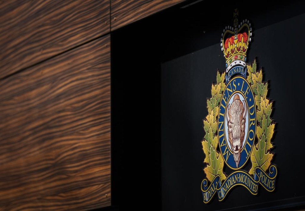 The RCMP logo is seen outside the force's 'E' division headquarters in Surrey, B.C., on March 16, 2023. Several British Columbia media reports say one of two Central Saanich Police officers charged with sexual assaulting a woman they met on duty has died by suicide. THE CANADIAN PRESS/Darryl Dyck