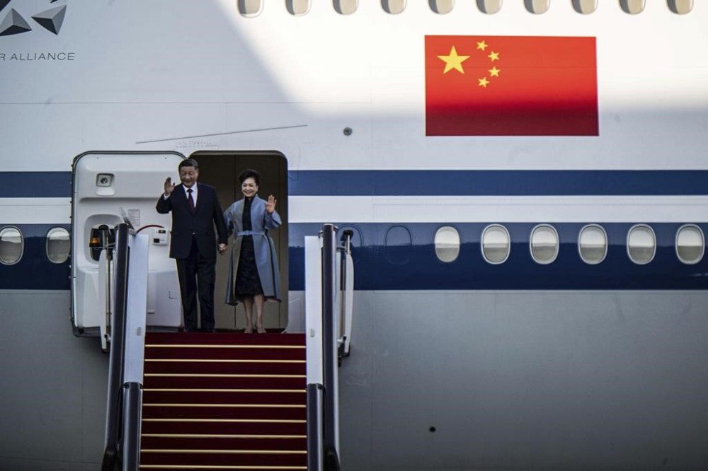 China's President Xi Jinping and his wife Peng Liyuan wave as they arrive at the airport in Macao, China, Wednesday, Dec. 18, 2024, ahead of celebrations marking the 25th anniversary of the casino city’s return to Chinese rule. (Eduardo Leal/Pool Photo via AP)
