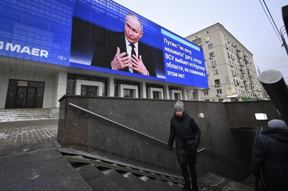 An electronic billboard on a building shows Russian President Vladimir Putin giving his annual news conference and call-in show in Moscow, Russia, Thursday, Dec. 19, 2024. (AP Photo/Dmitry Serebryakov)