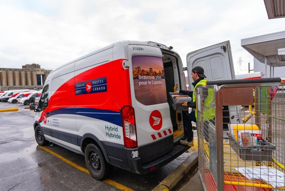 Canada Post has started accepting commercial volumes of letters and parcels as it works to get back to normal operations following a month-long strike. A Canada Post worker fills his truck with mail in Montreal on Tuesday, Dec.17, 2024. THE CANADIAN PRESS/Christinne Muschi