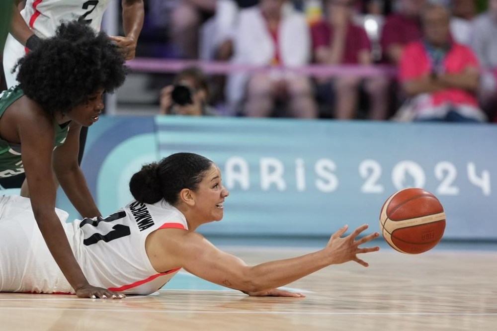 Natalie Achonwa (11), of Canada, makes a pass under Blessing Ejifor (22), of Nigeria, in a women's basketball game at the 2024 Summer Olympics, Sunday, Aug. 4, 2024, in Villeneuve-d'Ascq, France. Expectations for Canada's women's basketball team were high heading into 2024, but a disappointing finish in Paris has sparked a focus on rebuilding for the future. THE CANADIAN PRESS/AP/Mark J. Terrill