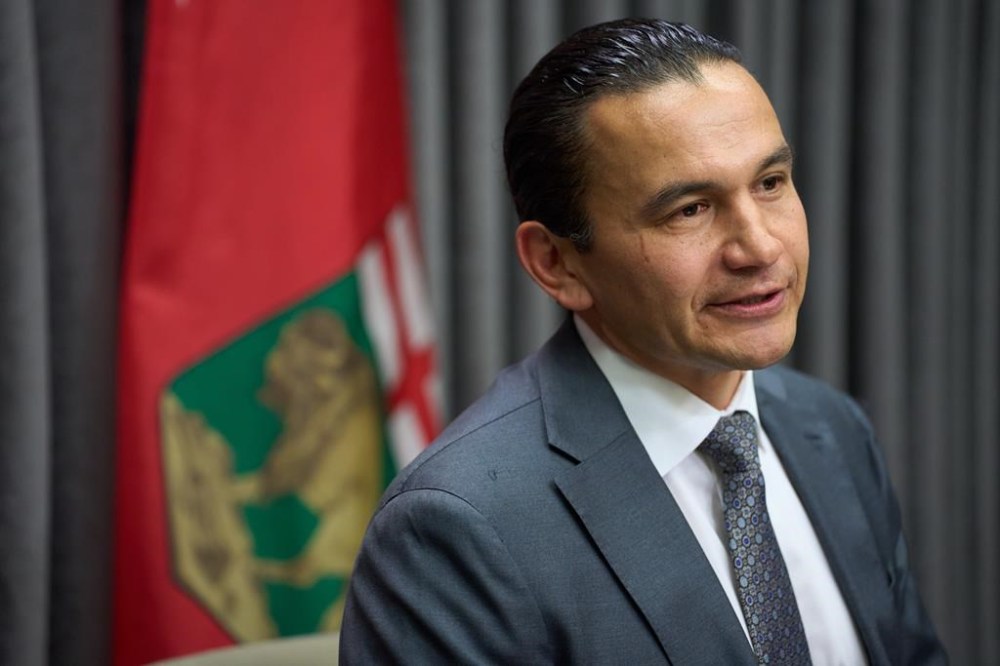 Manitoba Premier Wab Kinew speaks to the media at the Manitoba Legislative Building in Winnipeg on Tuesday, November 19, 2024. The Manitoba government's plan to replace paper health cards with more durable and modern plastic ones is running a bit behind schedule. THE CANADIAN PRESS/David Lipnowski