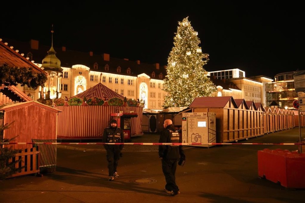 Security guards stand in front of a cordoned-off Christmas Market after a car crashed into a crowd of people, in Magdeburg, Germany, Saturday, Dec. 21, 2024. (AP Photo/Ebrahim Noroozi)