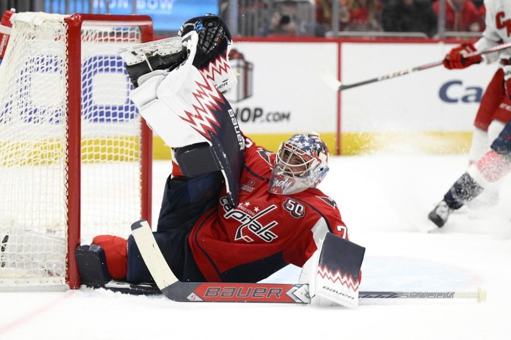 Washington Capitals goaltender Charlie Lindgren saves the puck during the second period of an NHL hockey game against the Carolina Hurricanes, Friday, Dec. 20, 2024, in Washington. (AP Photo/Nick Wass)