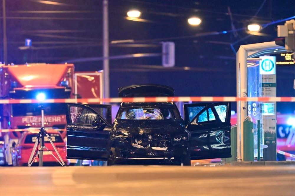 A damaged car sits with its doors open after a driver plowed into a busy Christmas market in Magdeburg, Germany, early Saturday, Dec. 21, 2024. (Hendrik Schmidt/dpa via AP)