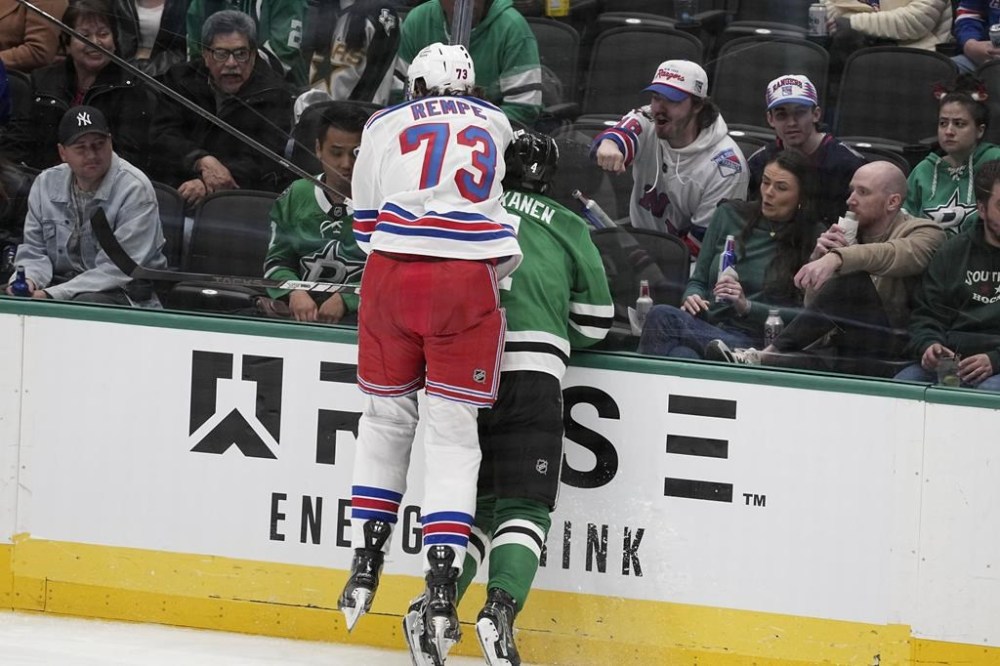 New York Rangers center Matt Rempe (73), who was ejected for game misconduct, slams Dallas Stars' Miro Heiskanen (4) against the boards in the third period of an NHL hockey game in Dallas, Friday, Dec. 20, 2024. (AP Photo/Tony Gutierrez)