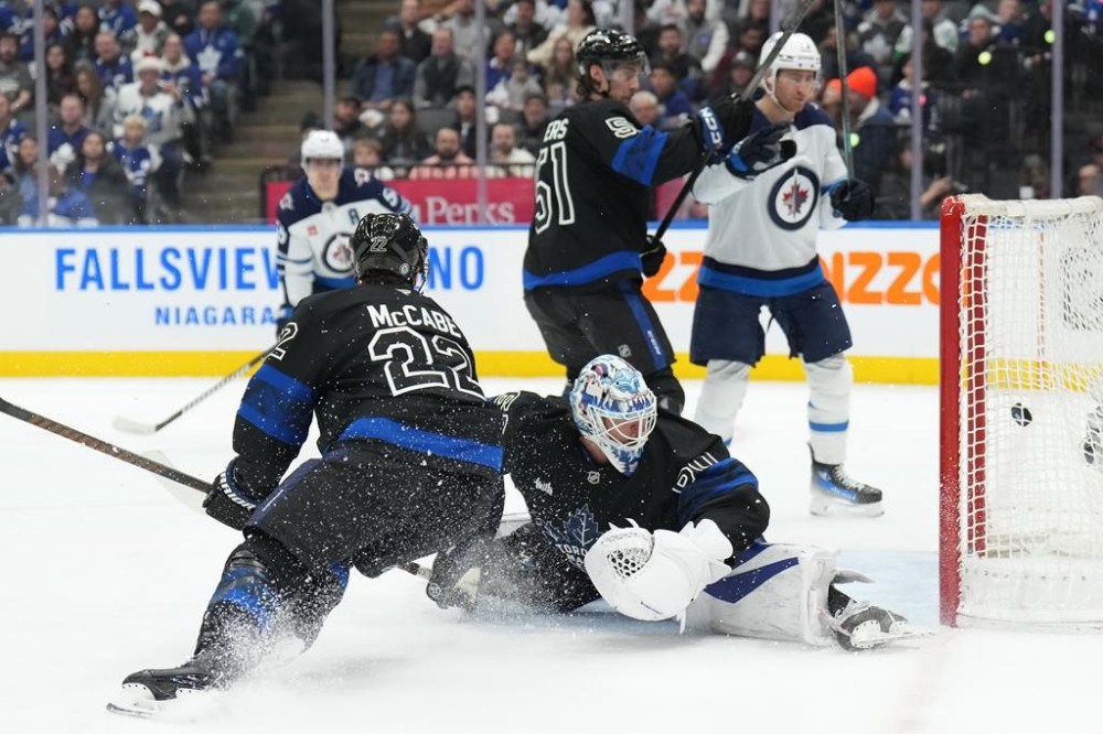 Toronto Maple Leafs goaltender Joseph Woll (60) looks back at his net as Winnipeg Jets left wing Kyle Connor scores during first-period NHL action in Toronto on Monday, Dec. 23, 2024. THE CANADIAN PRESS/Nathan Denette