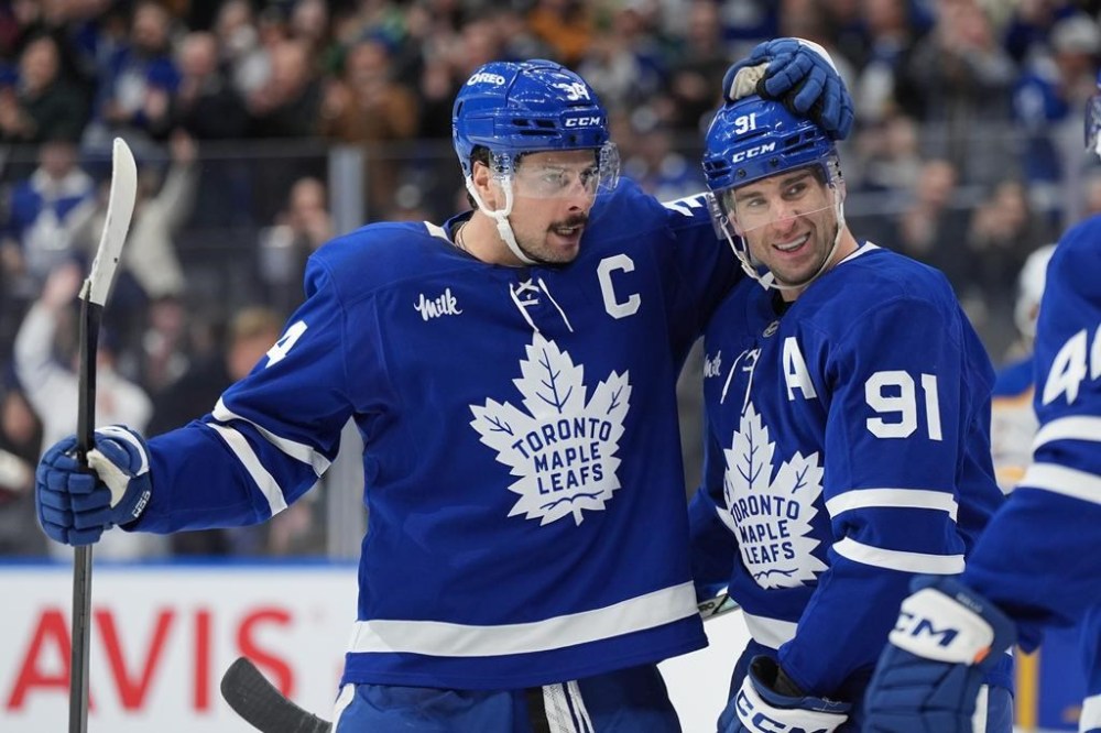 Toronto Maple Leafs centre John Tavares (91) celebrates his goal against the Buffalo Sabres with teammate Auston Matthews during second period NHL hockey action in Toronto, Sunday, Dec. 15, 2024. The Maple Leafs are placing captain Matthews on the injured reserve list with an upper-body injury.THE CANADIAN PRESS/Frank Gunn